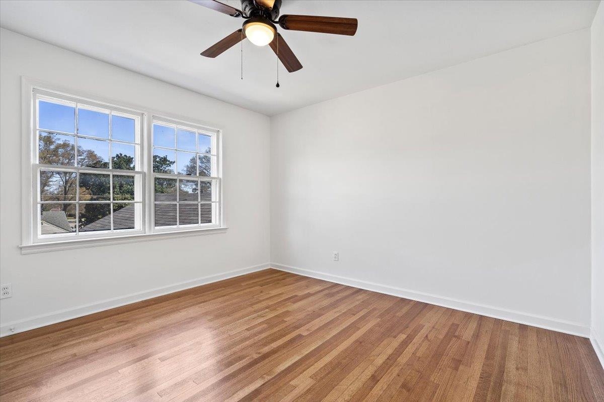 5600 Normandy Road Memphis, TN 38120 - Photo 25 of 28 Unfurnished room featuring a ceiling fan, light wood-style floors, and baseboards