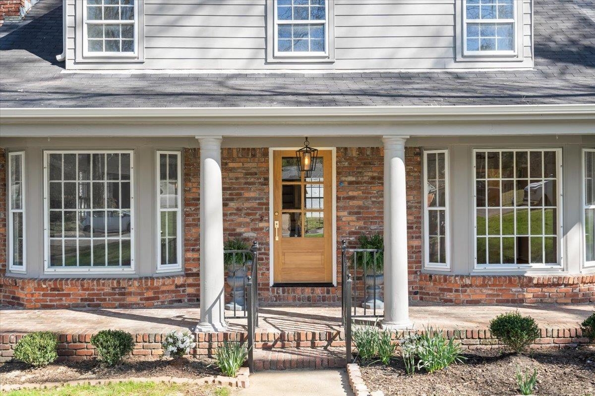 5600 Normandy Road Memphis, TN 38120 - Photo 4 of 28 Property entrance with brick siding, covered porch, and a shingled roof