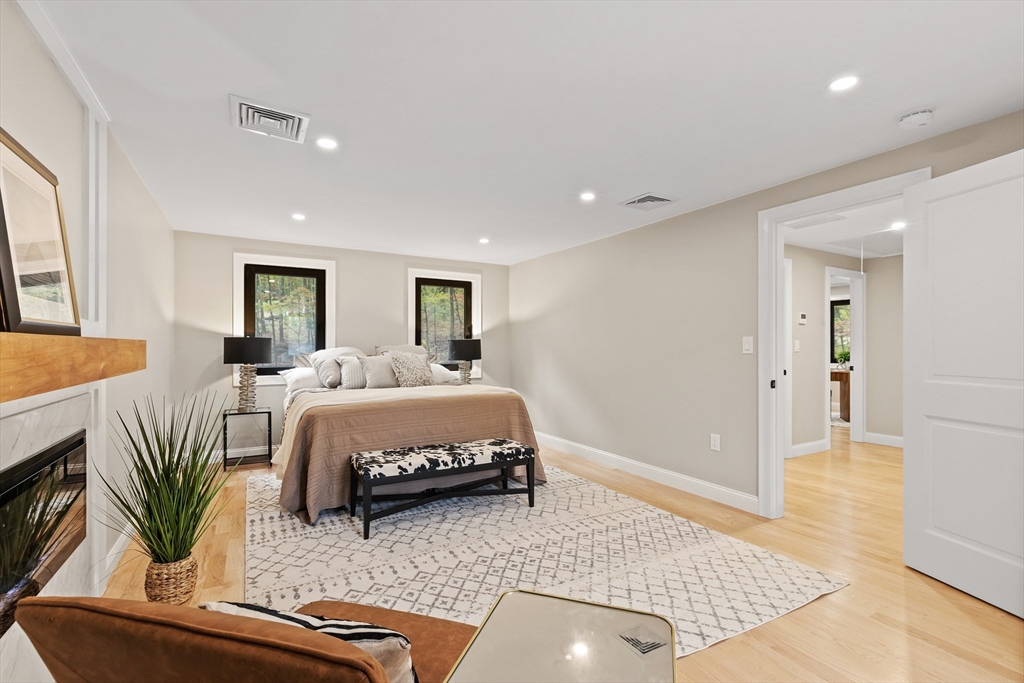 8 Mulberry Circle Ayer, MA 01432 - Photo 12 of 30 a spacious bedroom with a bed a couch and a potted plant