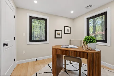 a dining room with furniture and window