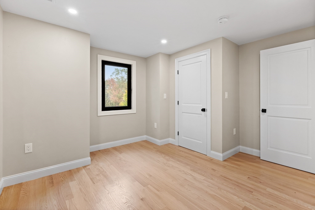8 Mulberry Circle Ayer, MA 01432 - Photo 19 of 30 a view of an empty room with wooden floor