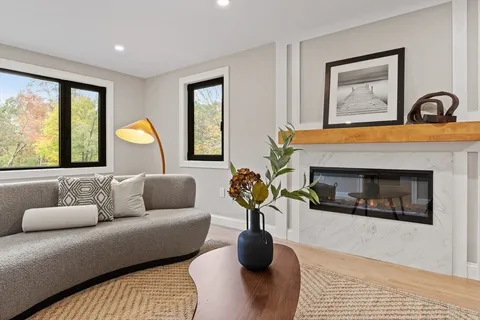 a living room with furniture and a fireplace
