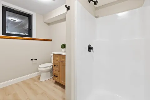 a white toilet sitting next to a bathroom sink
