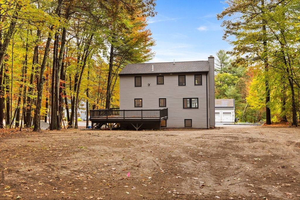 8 Mulberry Circle Ayer, MA 01432 - Photo 26 of 30 a view of a house with a large tree and a big yard