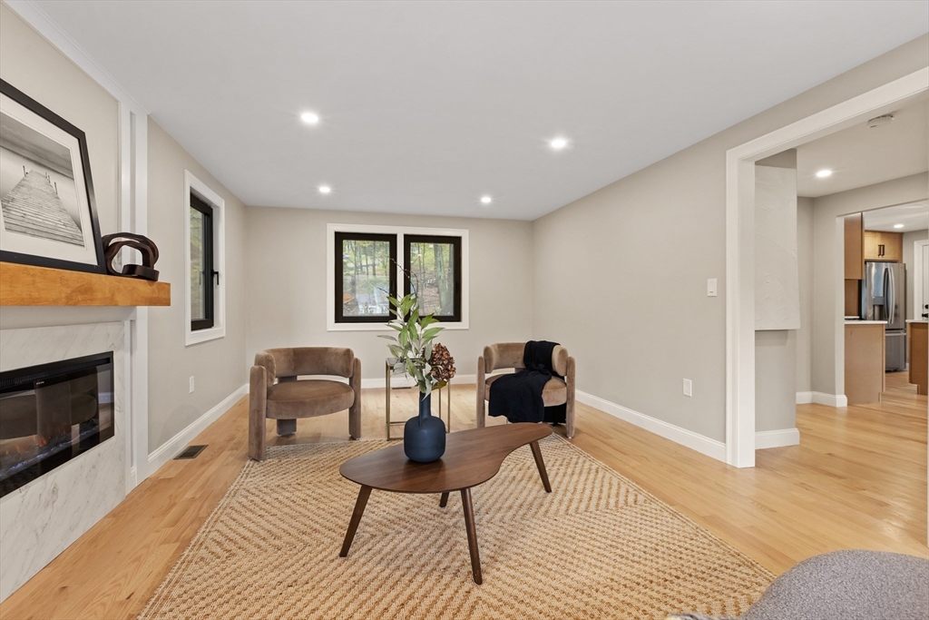 8 Mulberry Circle Ayer, MA 01432 - Photo 3 of 30 a living room with furniture a fireplace and wooden floor