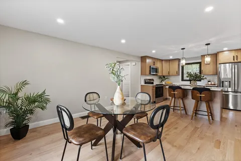 a view of a dining room with furniture and wooden floor