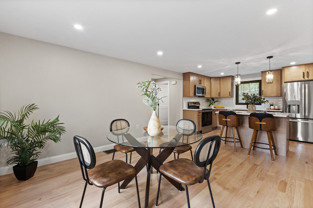 8 Mulberry Circle Ayer, MA 01432 - Photo 7 of 30 a view of a dining room with furniture and wooden floor