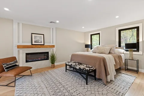 a bedroom with a bed and a fireplace