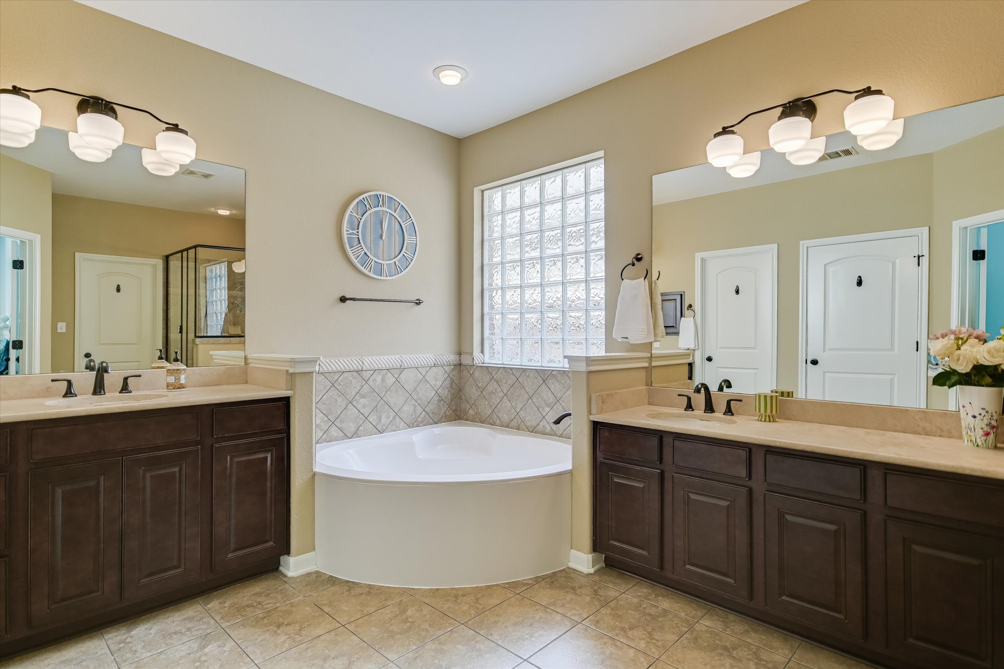 12312 Montclair Bend Austin, TX 78732 - Photo 20 of 40 Primary bath featuring separate vanities , garden tub , walk in shower & 2 walk in closets