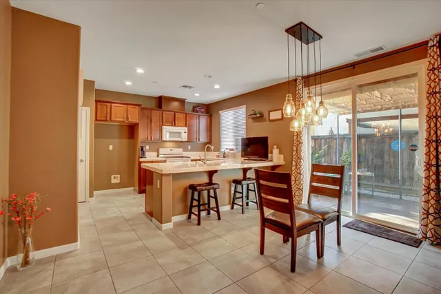 a kitchen with stainless steel appliances granite countertop a sink refrigerator and cabinets