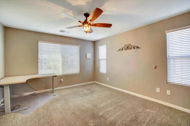 a view of a room with a ceiling fan