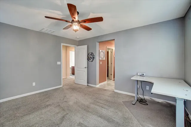 a view of room with a ceiling fan