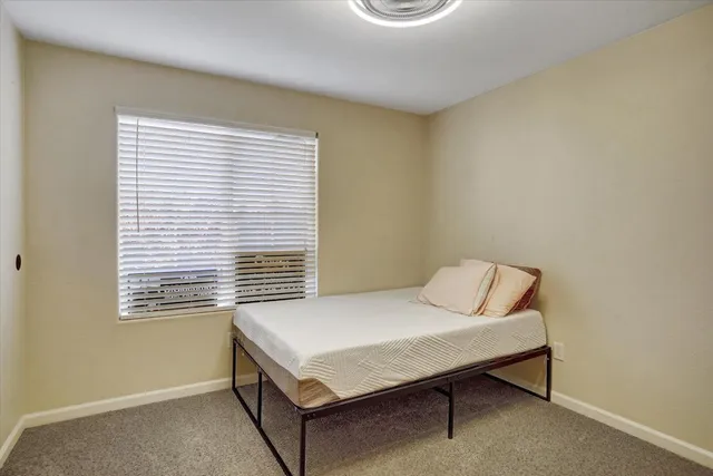 a room that has a bed and a table in it