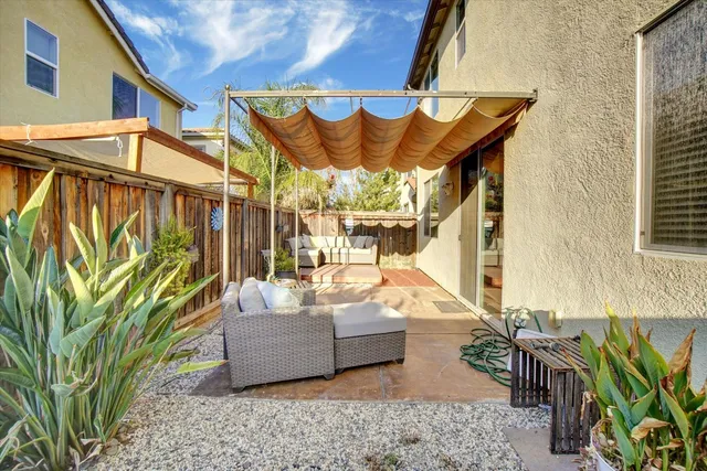 a view of a patio with a table and chairs and potted plants