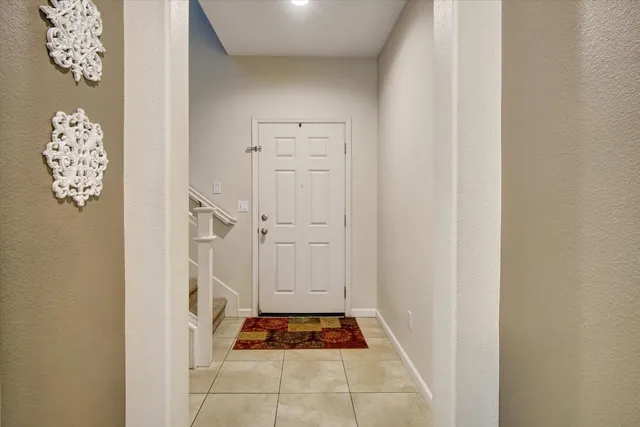 a kitchen with stainless steel appliances granite countertop a refrigerator a stove and a sink