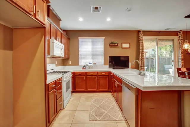 a kitchen with a sink and chairs