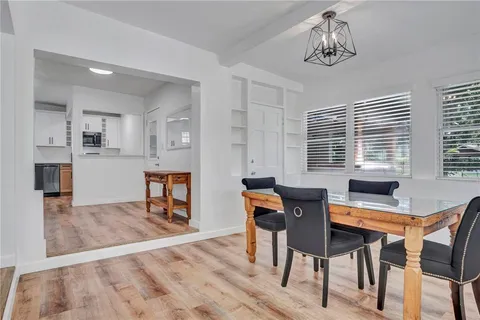 a view of a dining room with furniture and window