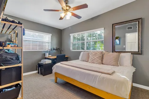 a bedroom with a bed and a chandelier