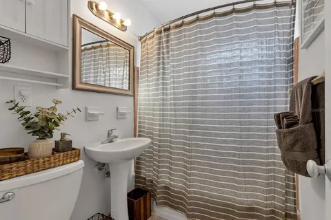 a bathroom with a sink a toilet and mirror