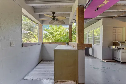 a view of a livingroom with a ceiling fan and window