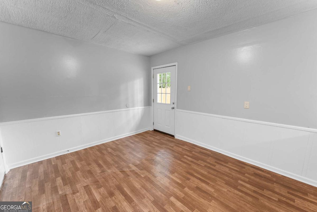 320 West Whatley Street Pooler, GA 31322 - Photo 26 of 34 a view of an empty room with wooden floor and a window