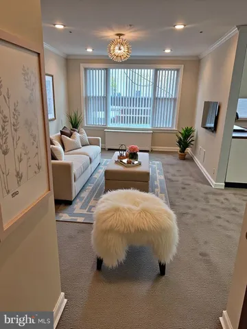 a bedroom with furniture and a large window