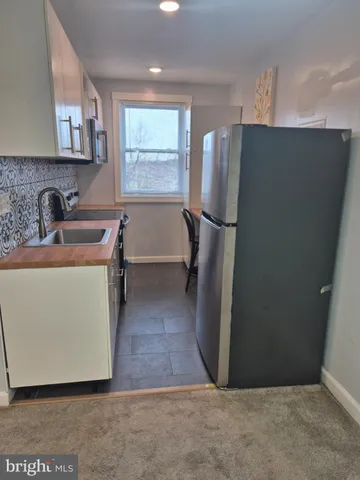 a kitchen with refrigerator and window