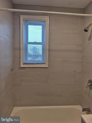 a bathroom with a shower and a window
