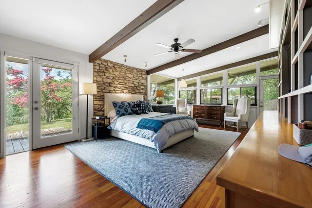 a bedroom with a large bed and a large window