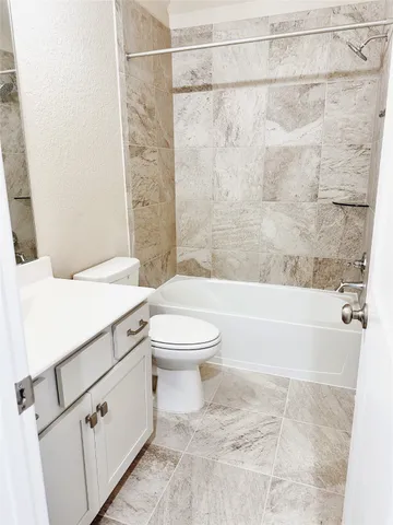 a view of a house with a big yard potted plants and large tree