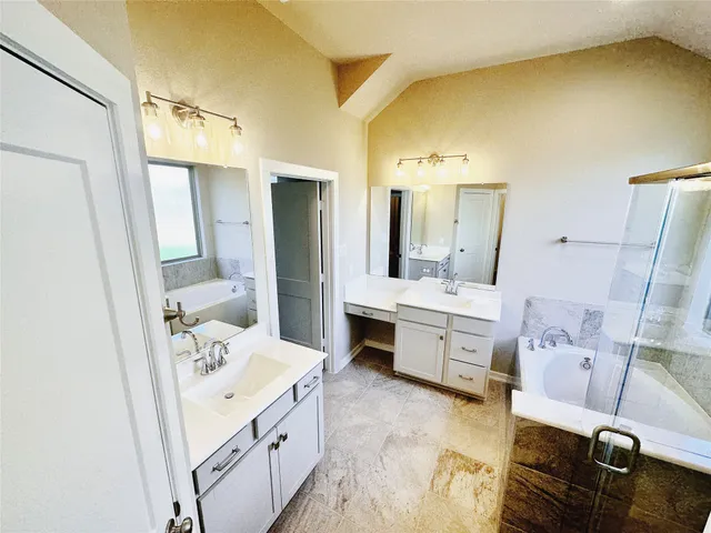 a bathroom with a tub sink and mirror