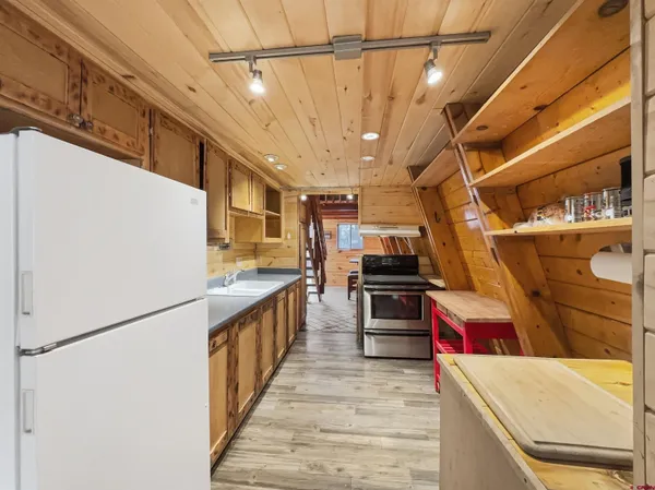 a kitchen with stainless steel appliances granite countertop a stove and a refrigerator