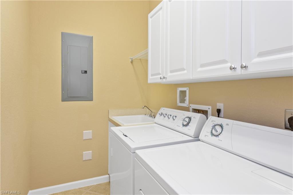 26425 Lucky Stone Road, Unit 201 Bonita Springs, FL 34135 - Photo 17 of 22 a utility room with dryer and washer