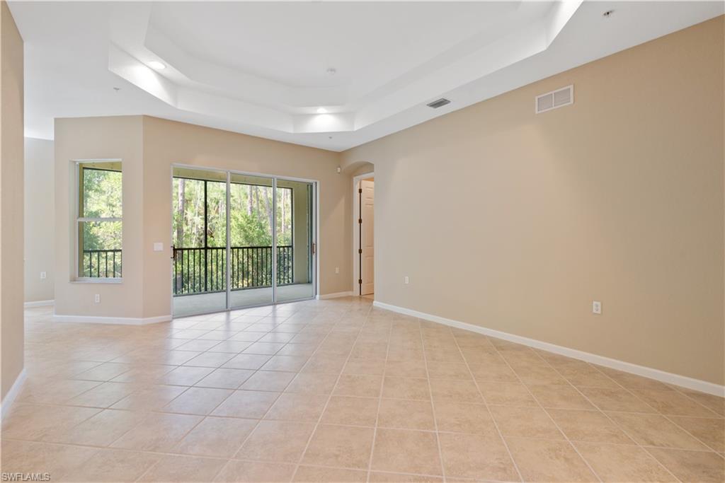 26425 Lucky Stone Road, Unit 201 Bonita Springs, FL 34135 - Photo 7 of 22 a view of an empty room with a sliding door