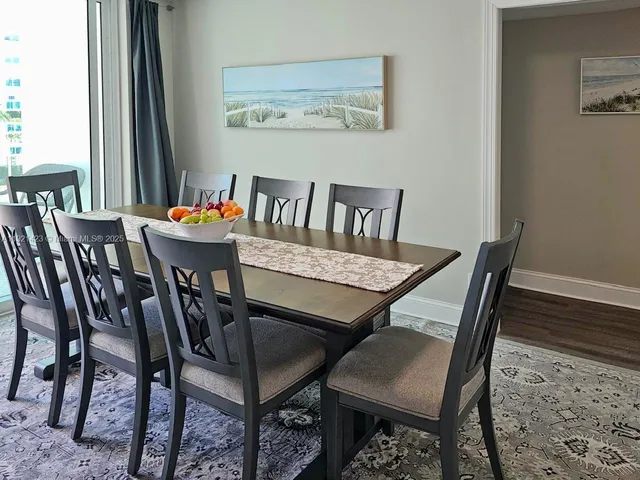 a dining room with furniture and wooden floor