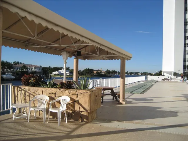 a view of a patio with table and chairs