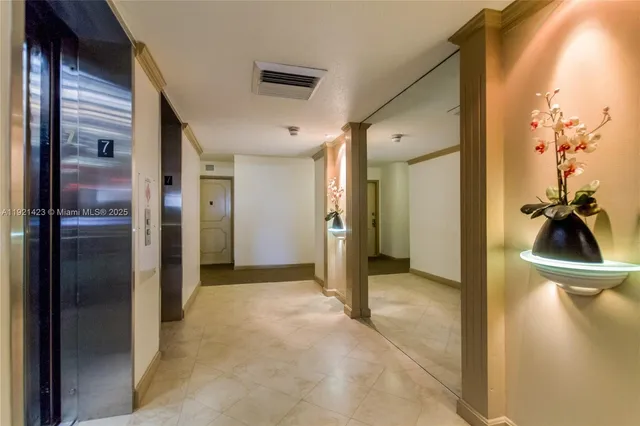 a view of a hallway with a livingroom and a hallway