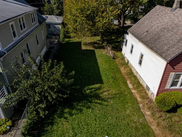 a aerial view of a house with a yard