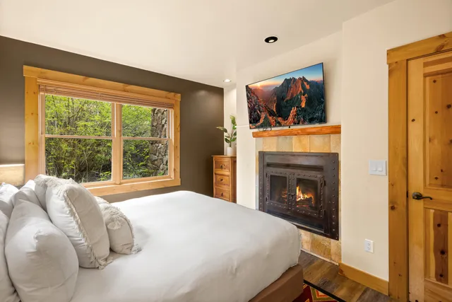 a bedroom with a bed and a fireplace