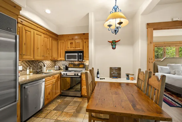 a kitchen with a sink appliances and cabinets
