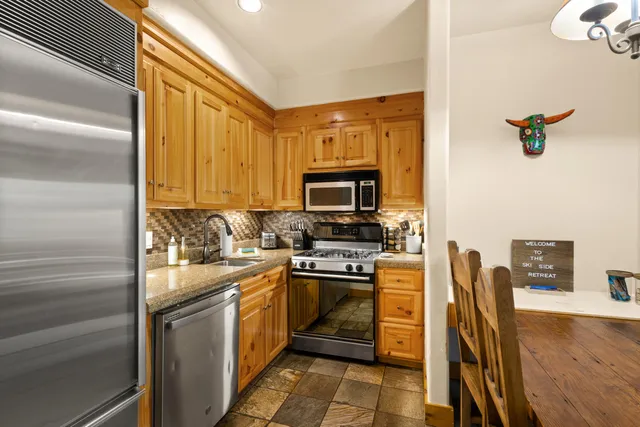 a kitchen with a sink appliances and cabinets