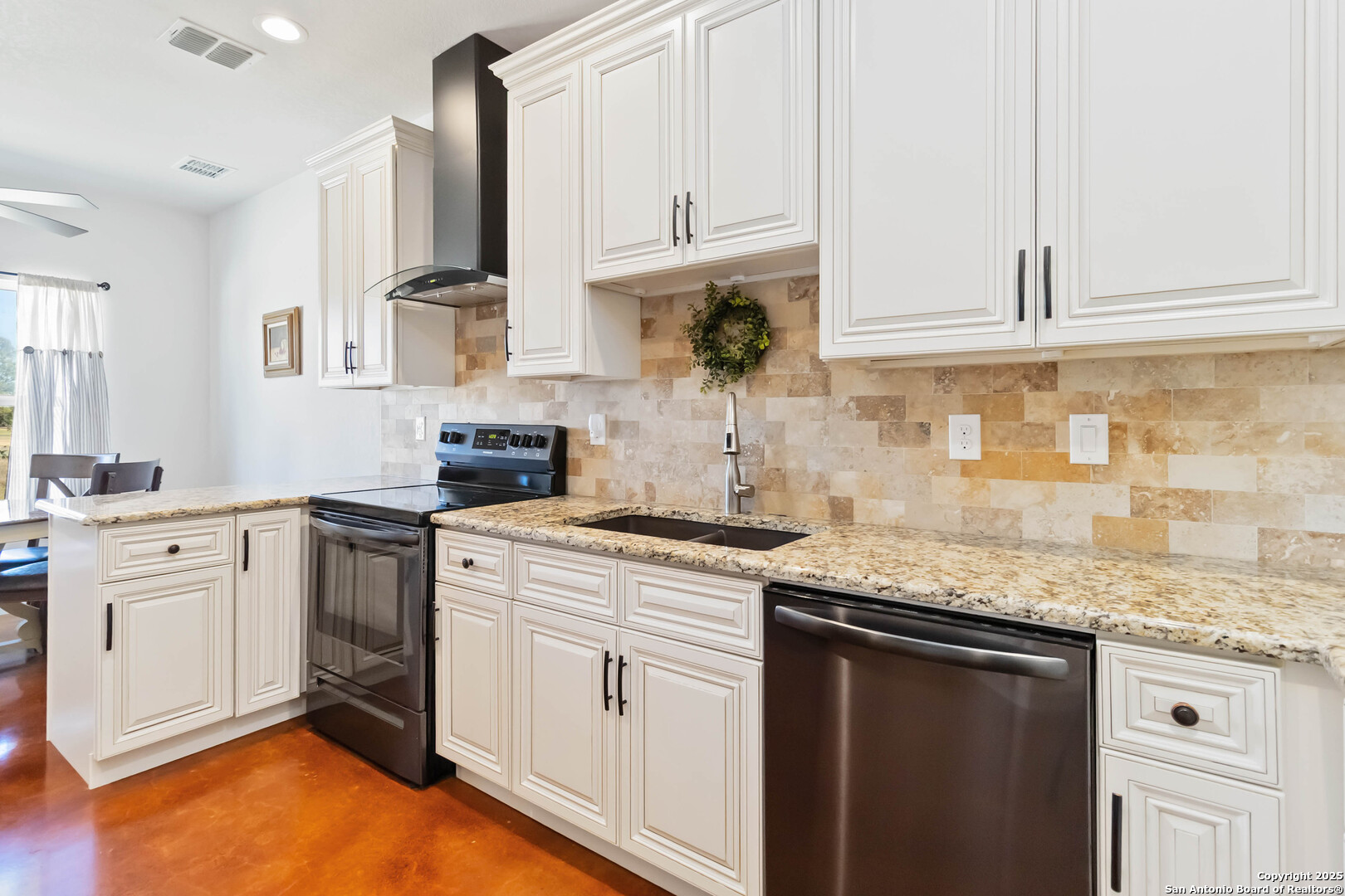 342 Wood View Circle Bandera, TX 78003 - Photo 11 of 45 a kitchen with granite countertop white cabinets and white appliances