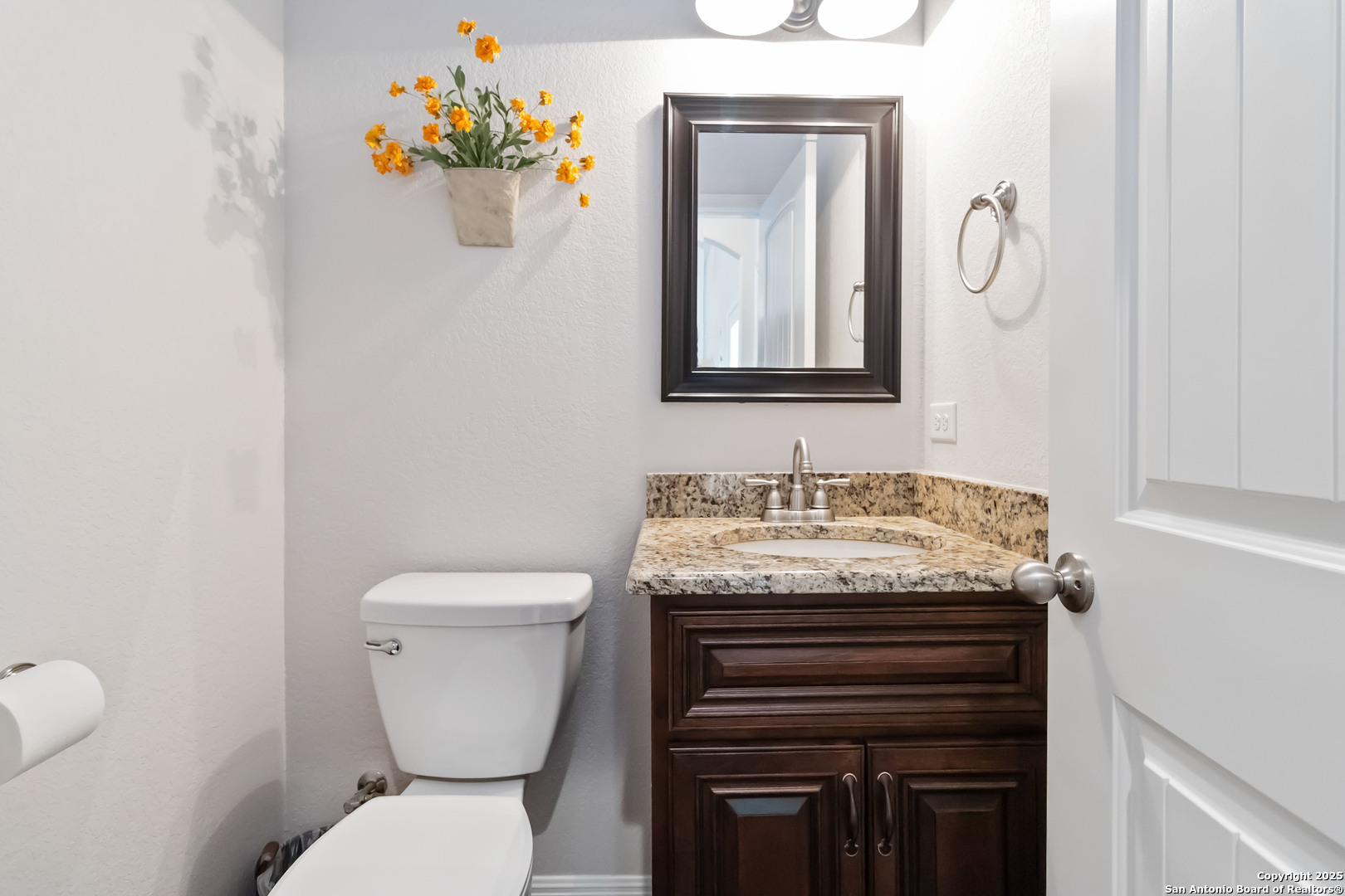 342 Wood View Circle Bandera, TX 78003 - Photo 32 of 45 a bathroom with a granite countertop toilet sink and mirror
