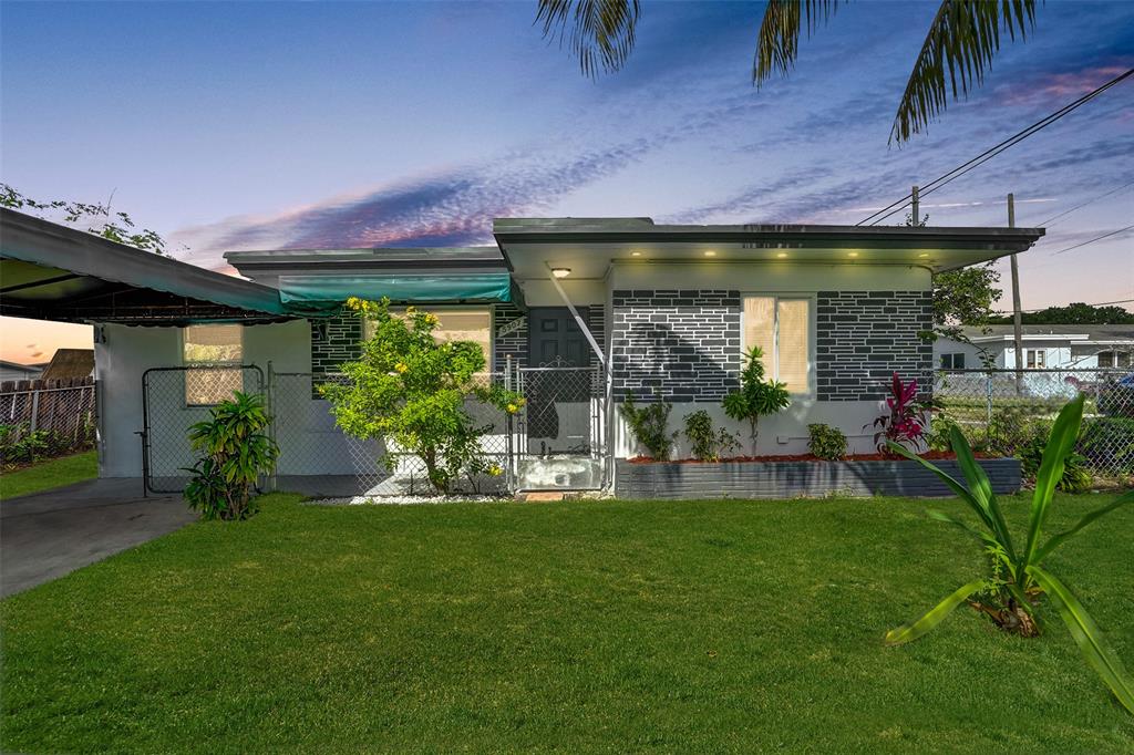 a front view of a house with garden and patio