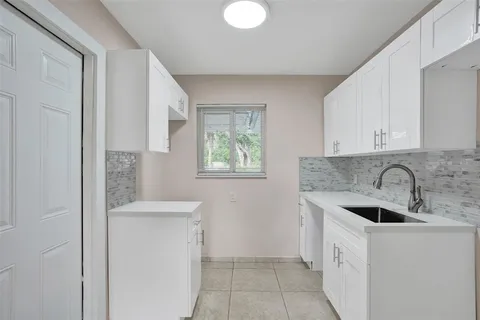 a kitchen with a sink and cabinets
