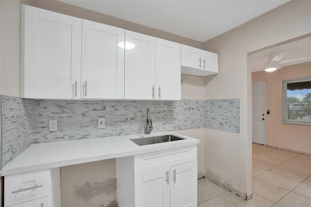 a kitchen with a sink and cabinets