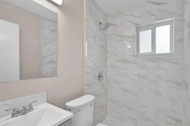 a bathroom with a sink toilet and shower