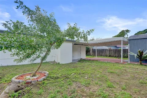 a backyard of a house with table and chairs