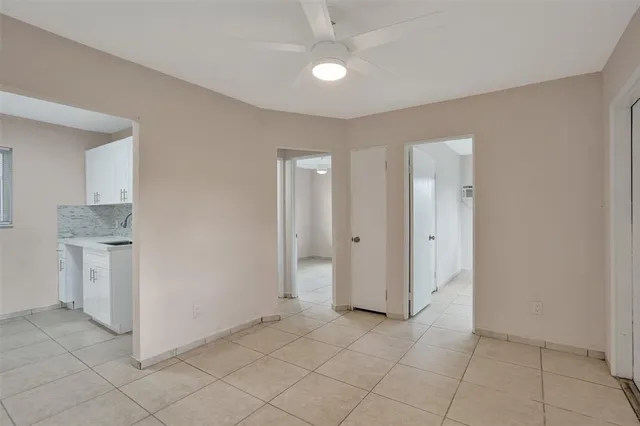 a view of a kitchen with white cabinets and sink