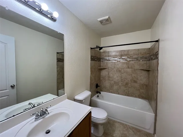 a bathroom with a sink a toilet and a bathtub